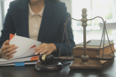 A tax lawyer at her desk rifling through a client's tax records.