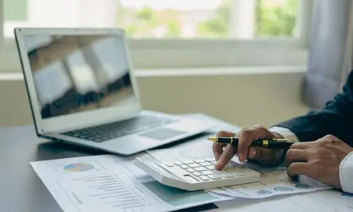 A tax professional filing documents for a client to get ready for an IRS revenue officer's visit.