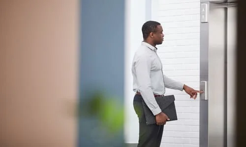 An IRS revenue officer ringing the doorbell on a home visit to a taxpayer's house.