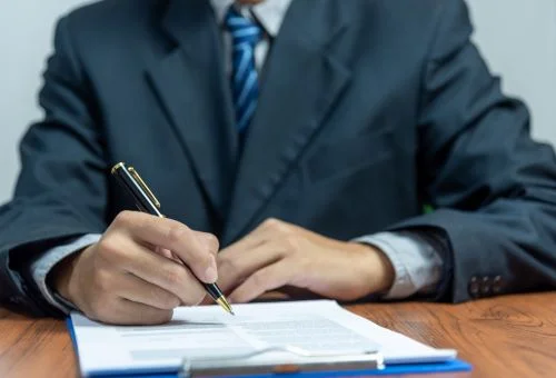 An accountant fills out paperwork to remove a federal and state tax lien.