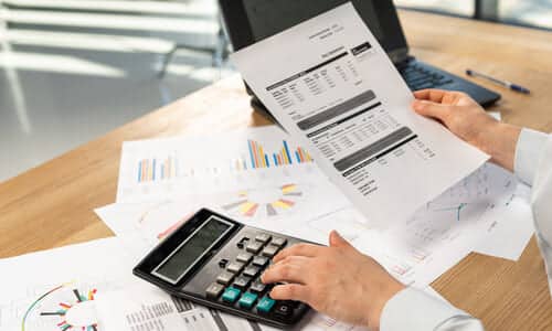 A tax expert at his desk looking at the income of a client to waive wage garnishments.