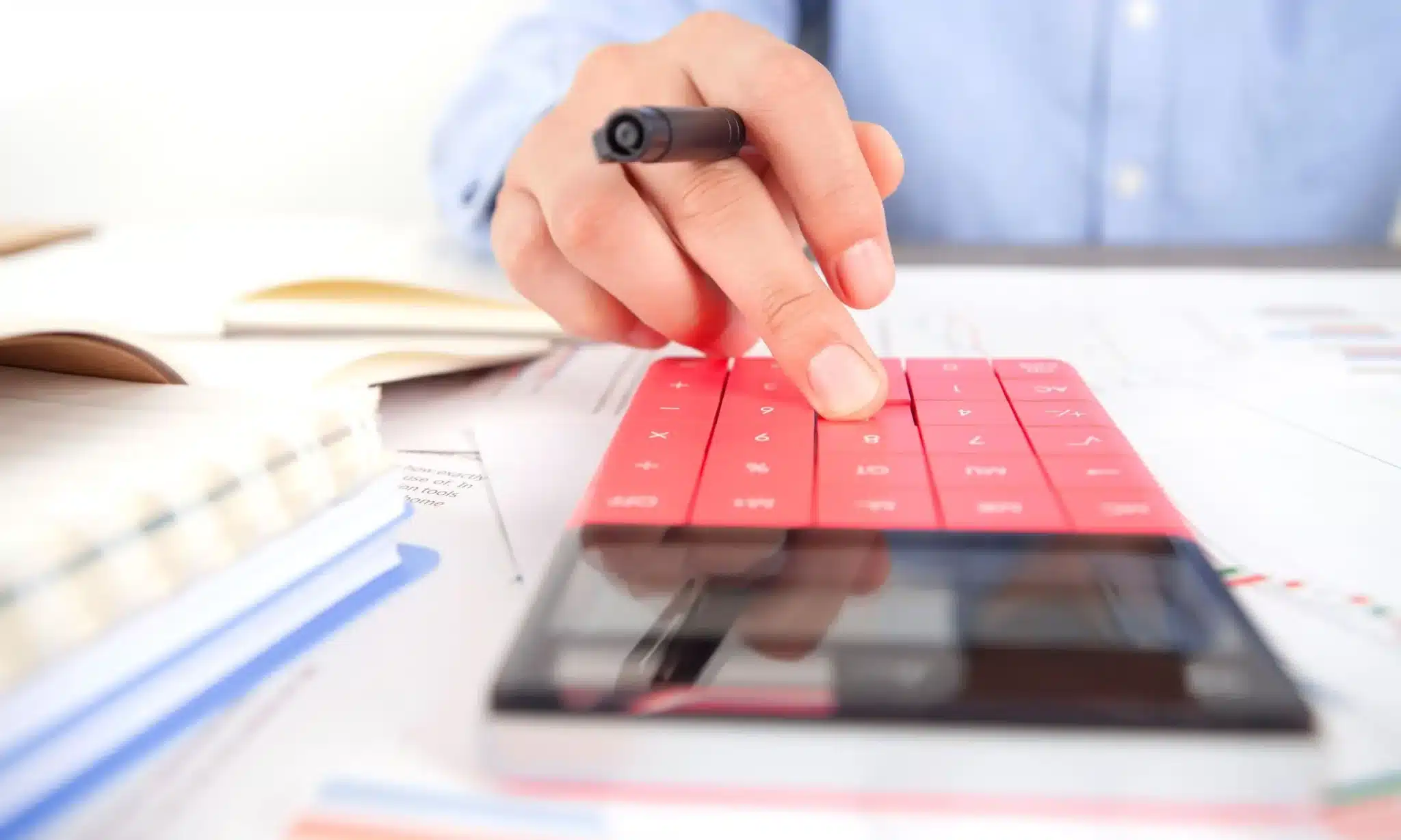 A tax expert on a calculator working on a client's offer in compromise.