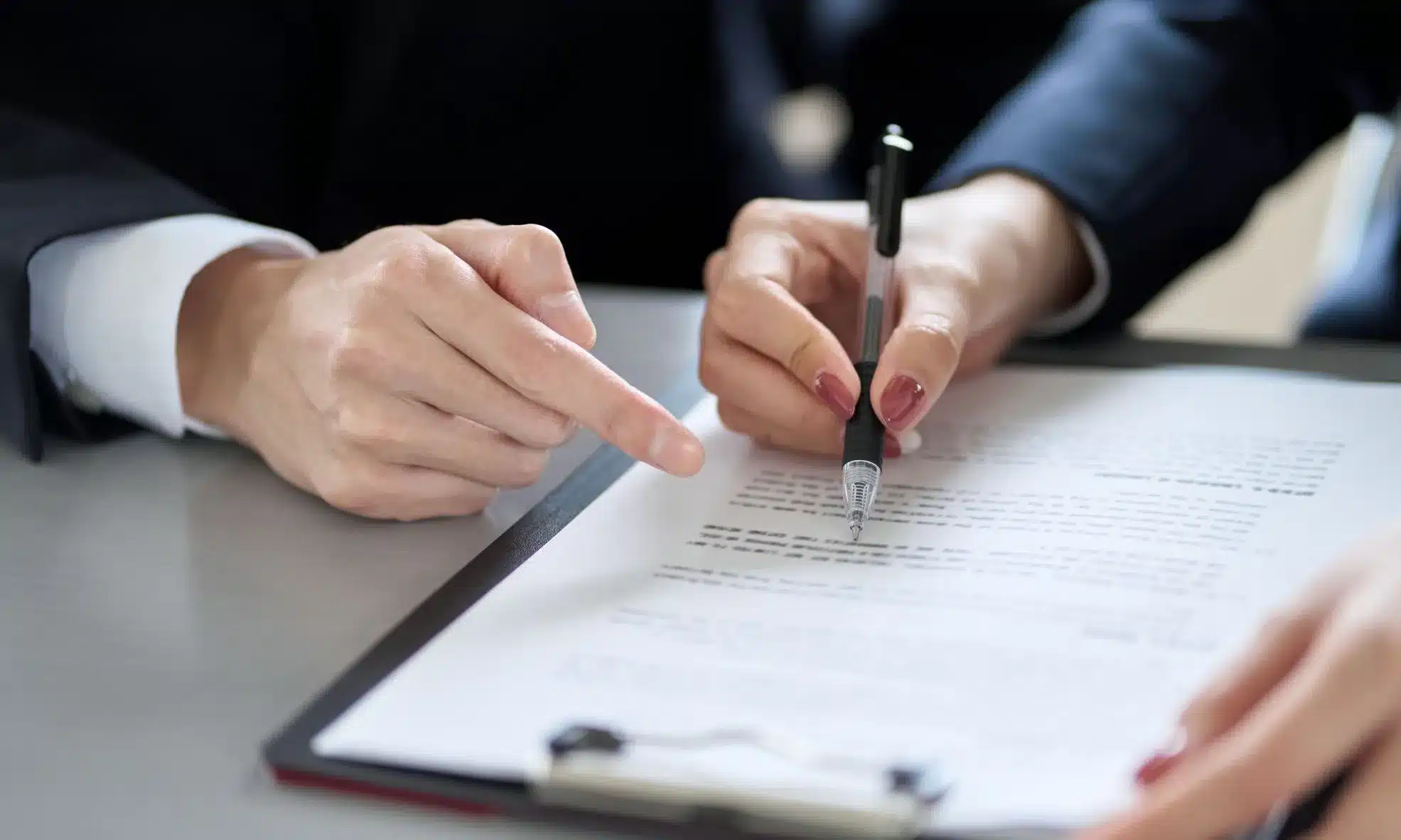 A Montana tax professional and his client at a desk taking a look at the latter's financial situation.