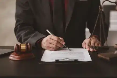 A tax lawyer takes notes in a legal book.