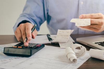 A tax professional holding receipts and a working to get a client an offer in compromise.