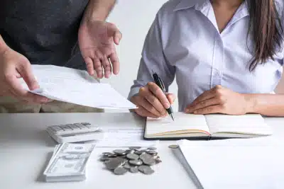 A couple going through tax records and expenses after receiving a notice from the IRS.