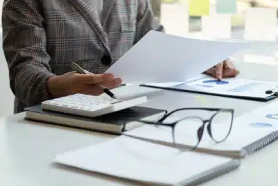 A tax expert holding documents in her hands while working to relieve a client's wage garnishments.