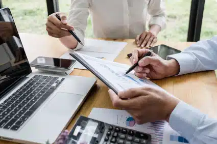 A tax professional meeting with a client in an office and working together.