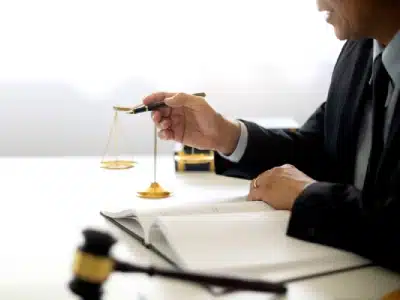 Close-up of a Lakewood tax lawyer pointing with a pen while reviewing a tax case with a client.