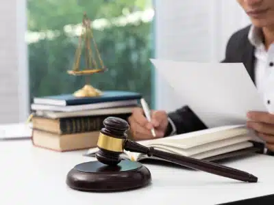 A tax lawyer in an Arvada law office reviewing tax records while sitting at an office table.