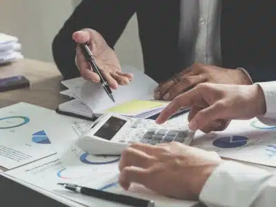 A team of Columbine tax lawyers studying and discussing the company taxes of their major client.