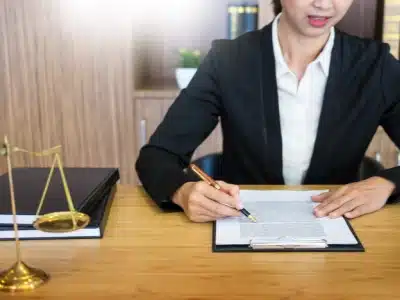 A female Commerce City Tax Lawyer going over documents while holding a pen in her hand