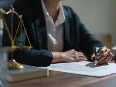 A Northglenn Tax Lawyer signing documents while seated in their law office